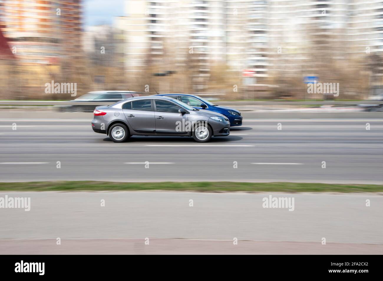 Ukraine, Kyiv - 6 April 2021: Gray Renault Fluence car moving on the street. Editorial Stock Photo