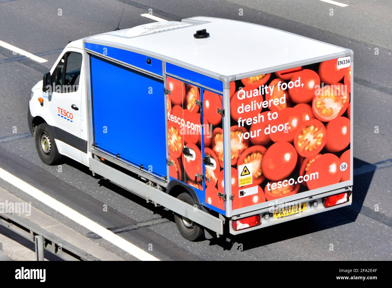 Aerial top side & back of Tesco supermarket van a food supply chain retail business transport delivery online internet grocery shopping on UK motorway Stock Photo