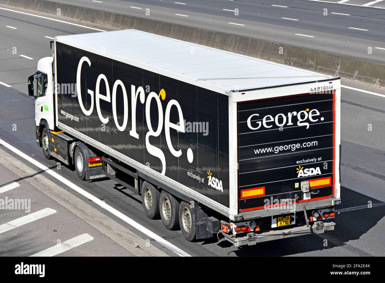 Side back & top view of Asda supermarket lorry truck & a George clothing fashion brand name logo on articulated supply chain trailer  on UK motorway Stock Photo