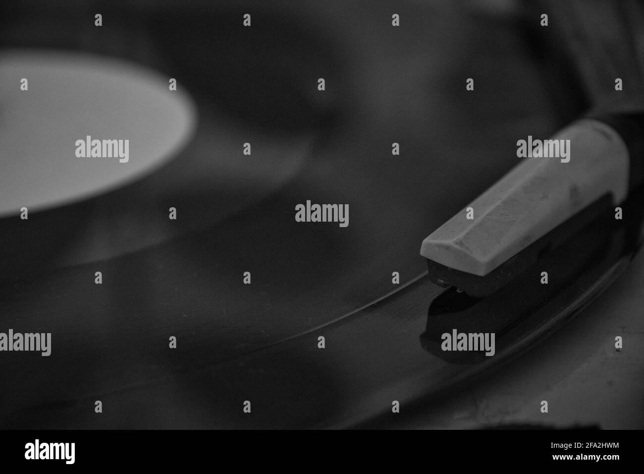 Black and white close-up shot of retro turntable playing a record Stock Photo