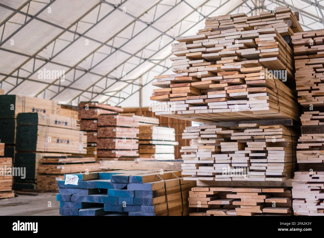 Kingston, NH, US-March 12, 2021: Stacks of lumber on a rack for sale to consumers at a retail hardwood lumber business Stock Photo