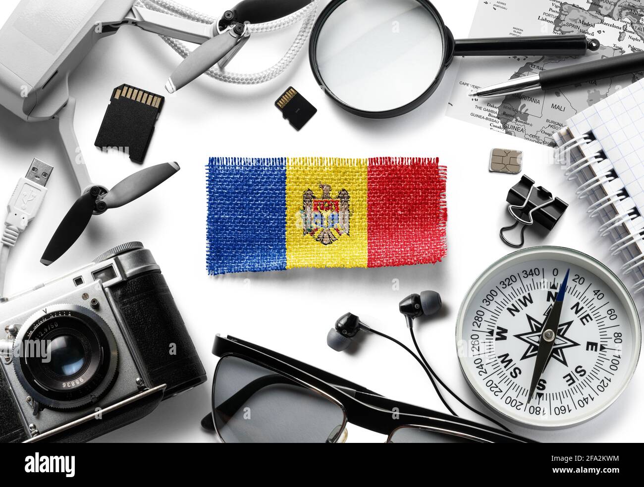 Flag of Moldavia and travel accessories on a white background. Stock Photo