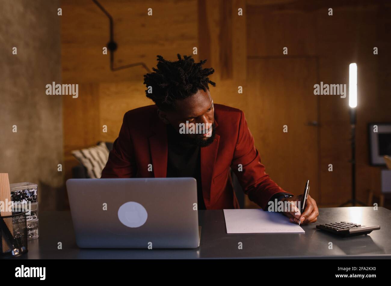 black business man working on laptop and taking notes Stock Photo