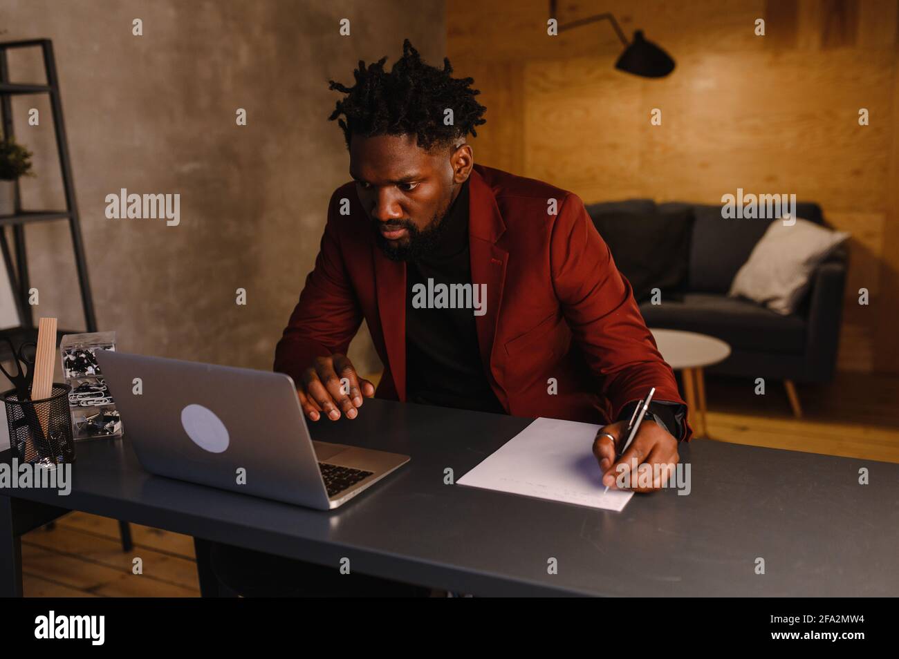 black business man working on laptop and taking notes Stock Photo