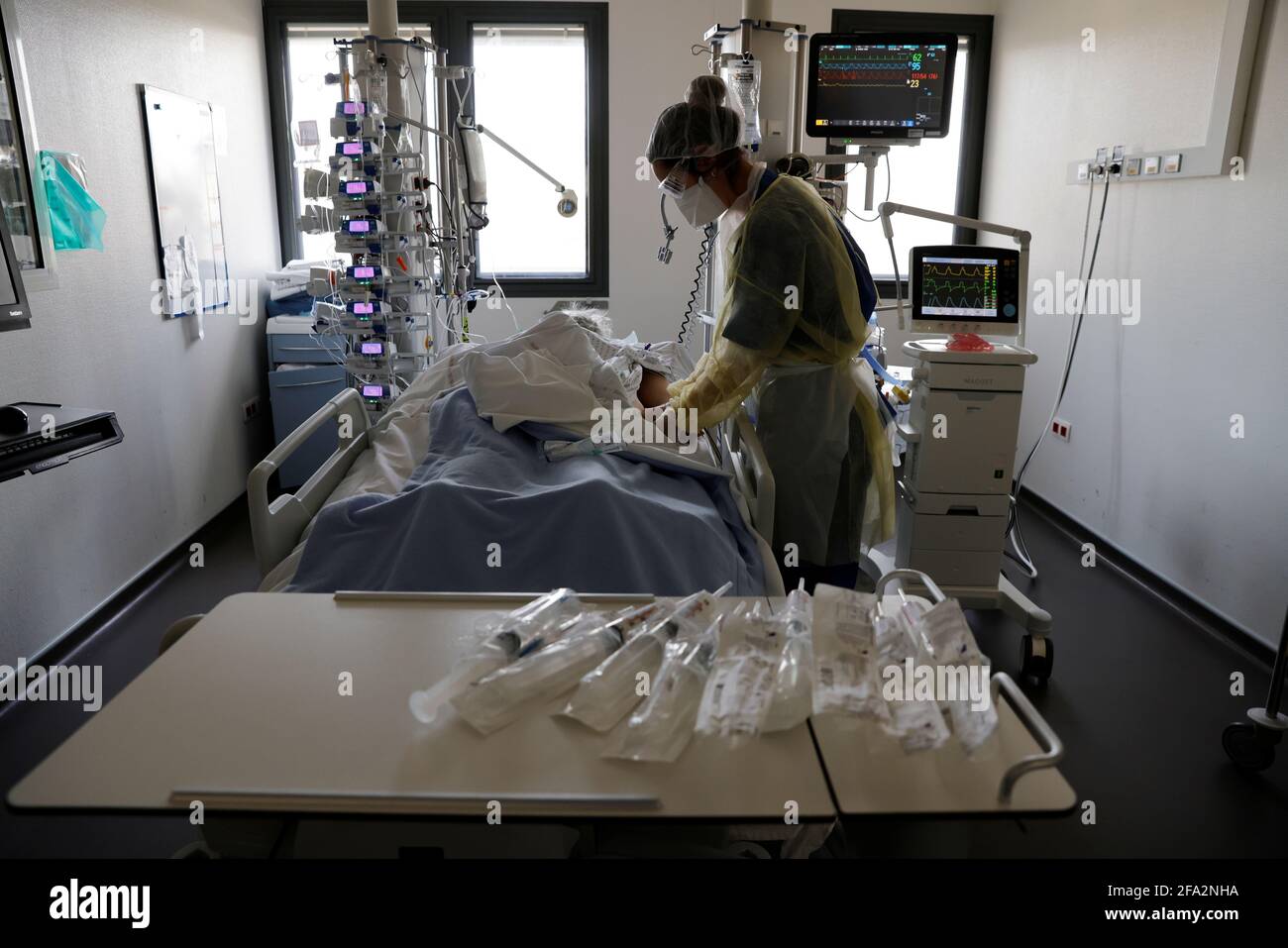 A medical staff member, wearing protective gear, works in the Intensive  Care Unit (ICU) where patients suffering from the coronavirus disease  (COVID-19) are treated at the hospital in Valenciennes, France, April 22,