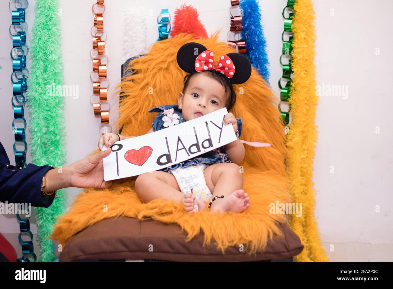 Closeup Shot Of A Cute Happy Indian Female Baby Sitting On A Teddy Bear Holding An I Love Daddy Sign Stock Photo Alamy