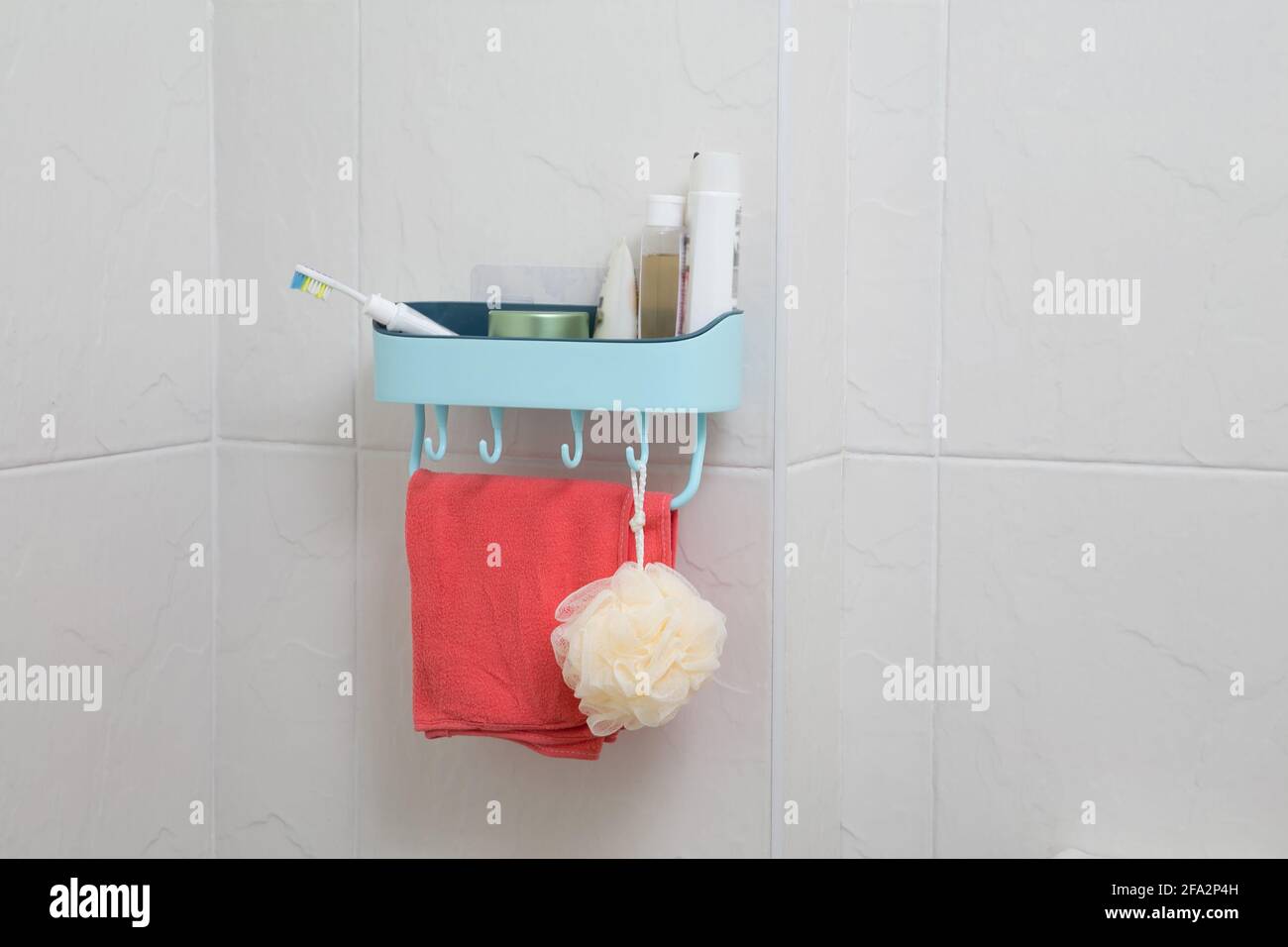 bathroom shelf with bathroom accessories against the white tile wall Stock Photo Alamy