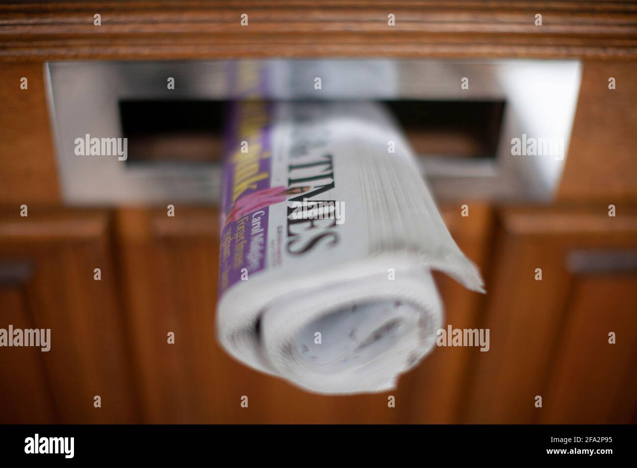 Daily newspaper in front door  letterbox Stock Photo