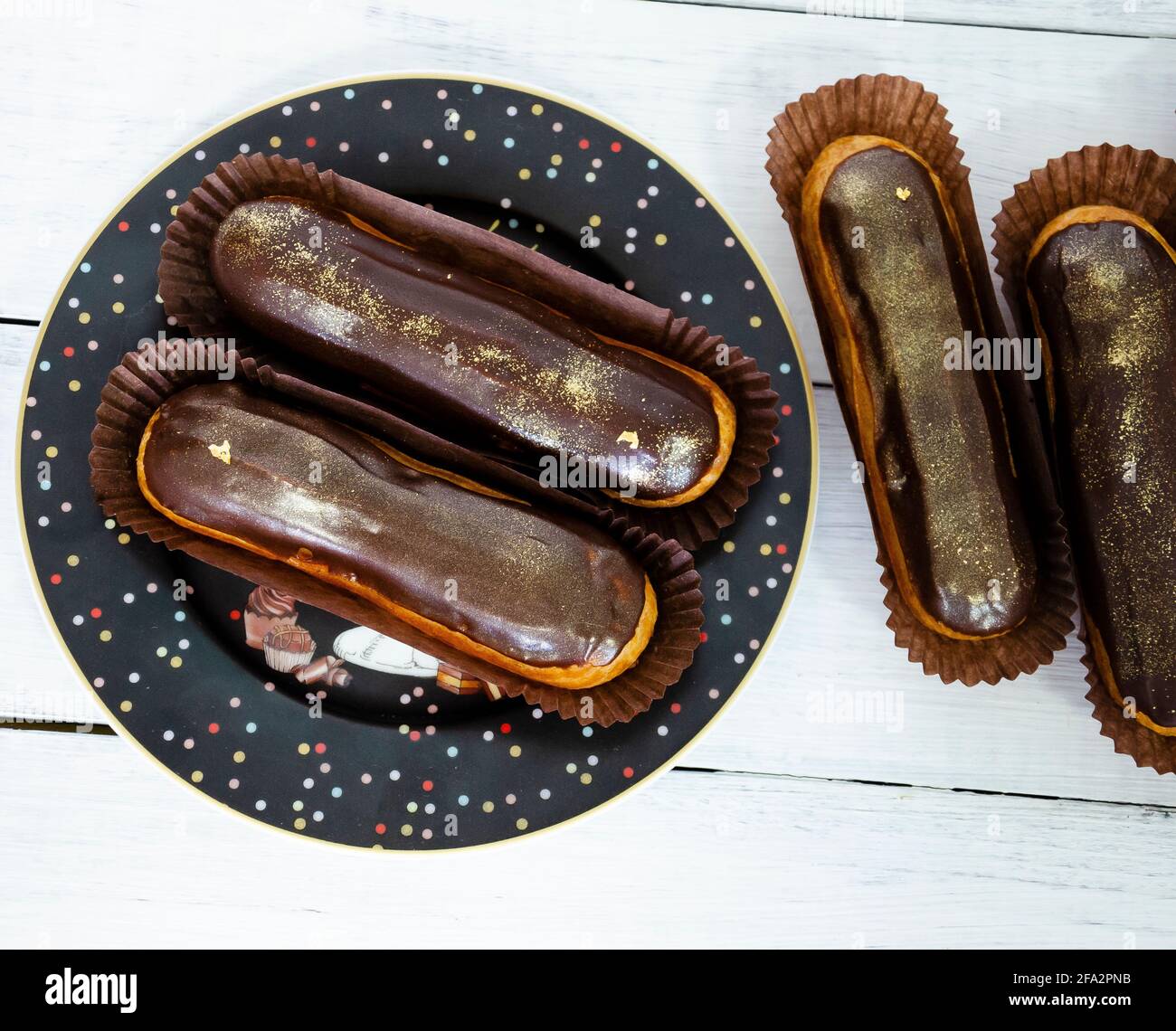 Gorgeous extra chocolate eclairs with gilded glaze Stock Photo