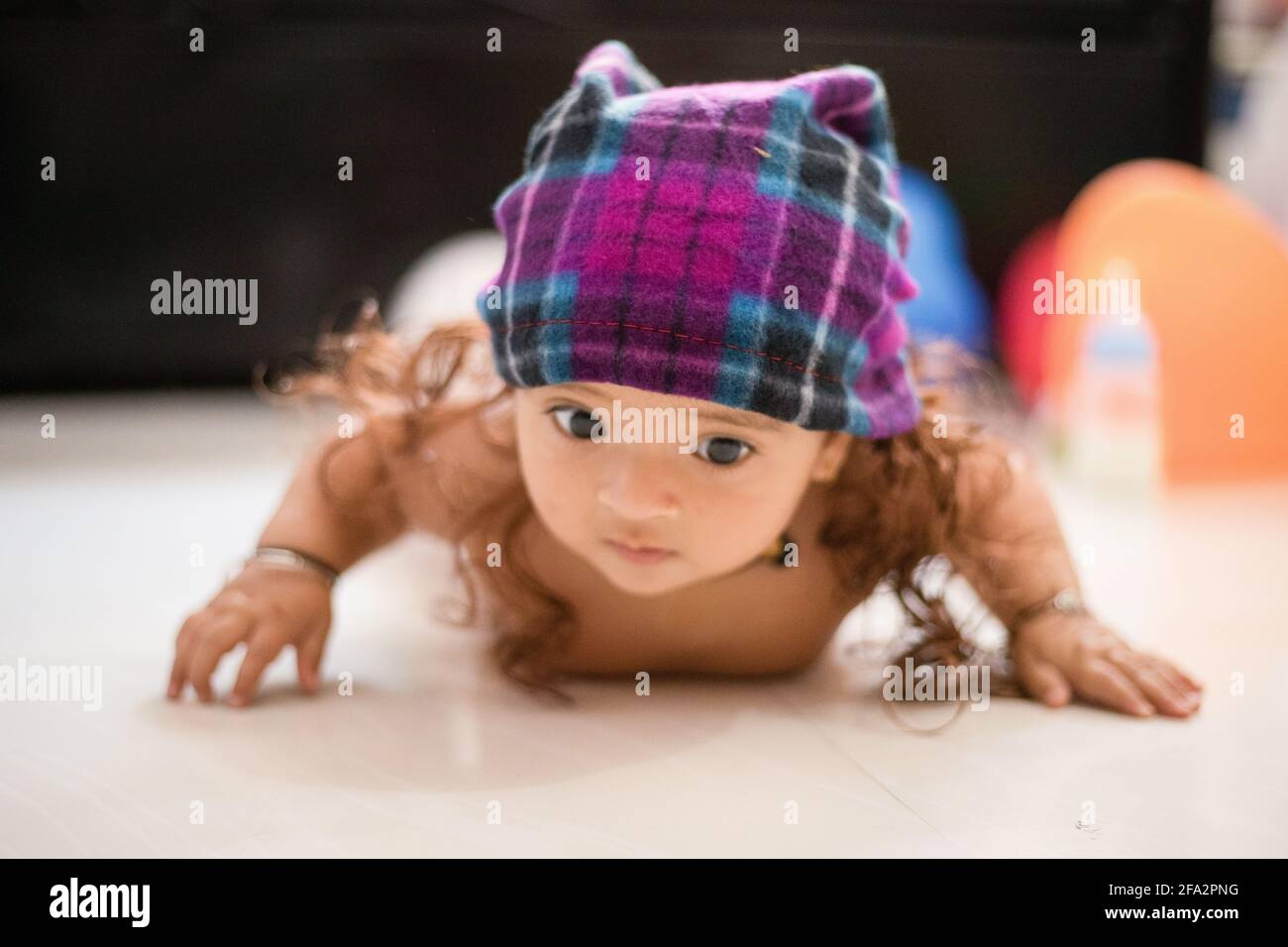 Closeup shot of a cute happy Indian female baby wearing a hat with fake hair  Stock Photo - Alamy