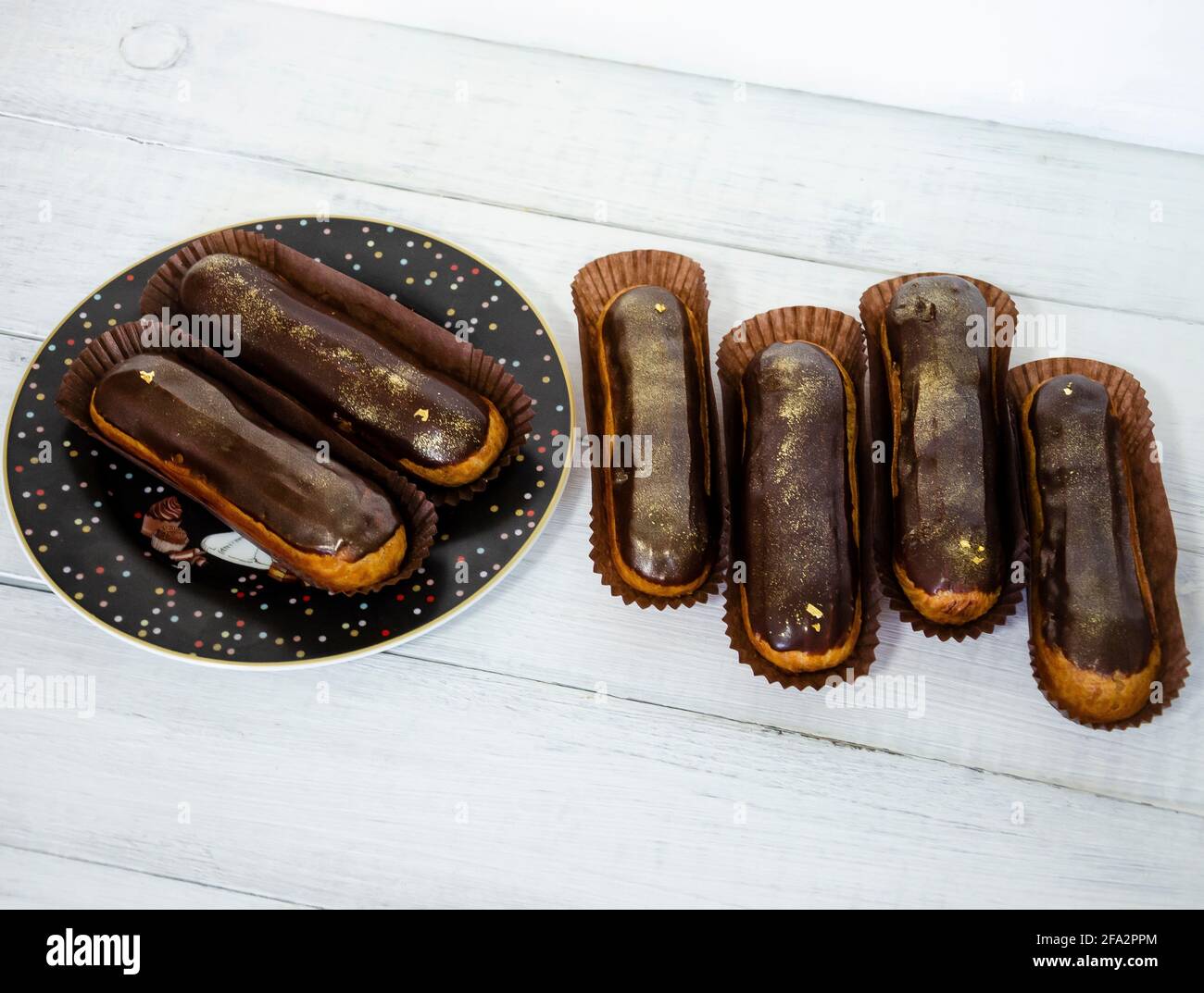 Gorgeous extra chocolate eclairs with gilded glaze Stock Photo
