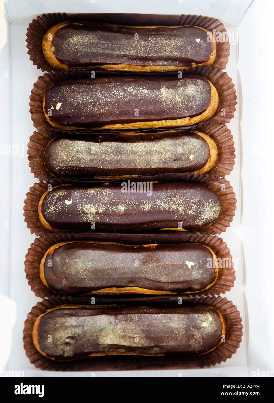 Gorgeous extra chocolate eclairs with gilded glaze Stock Photo