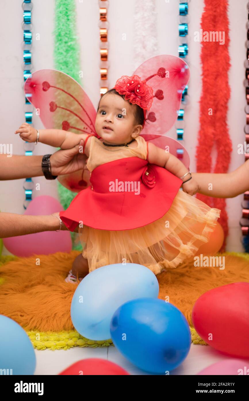 Vertical closeup shot of a cute Indian female baby in a fairy costume at a birthday party Stock Photo Alamy