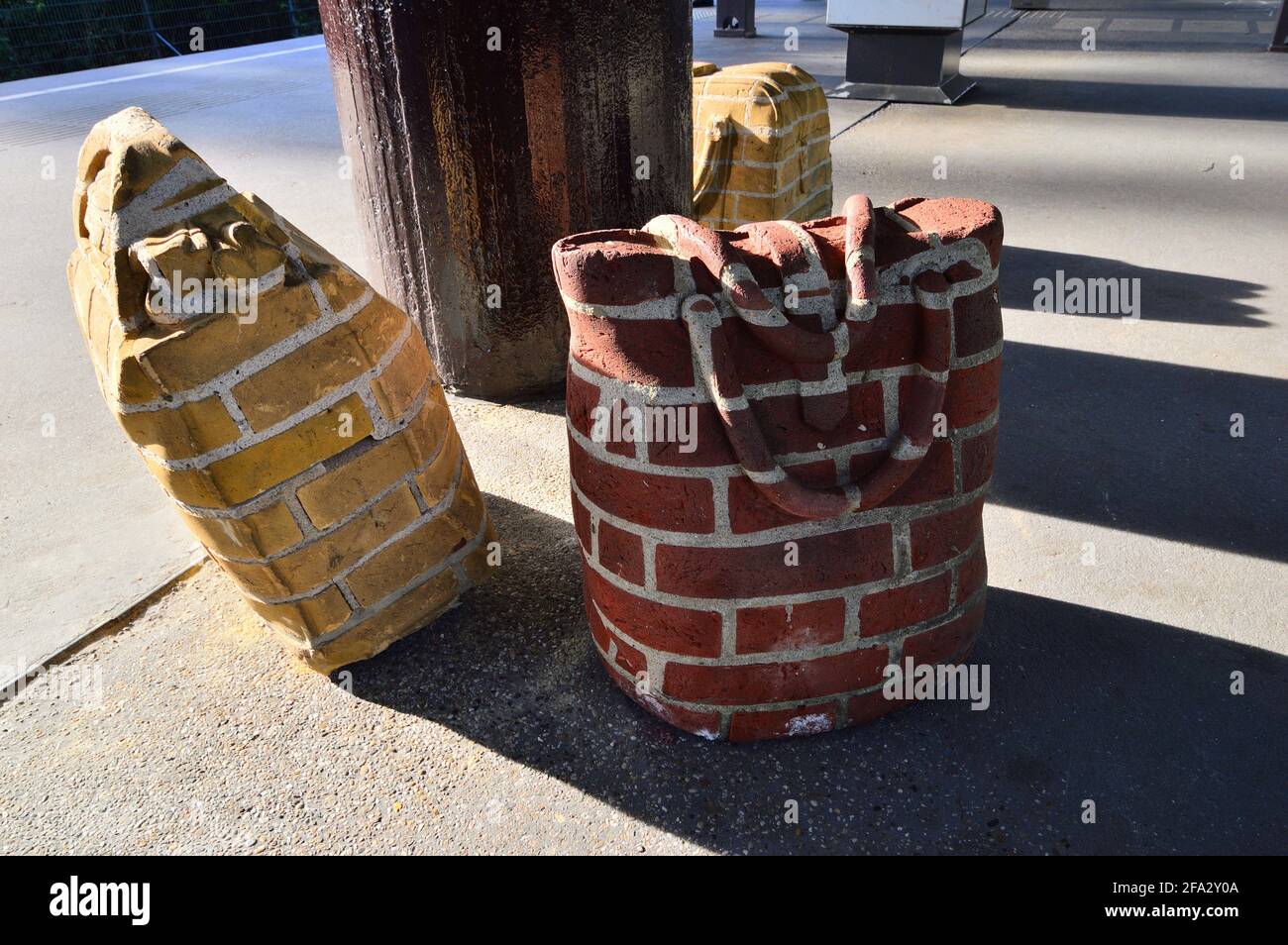 Unusual brick suitcases in the summer sun on a railway platform. Amsterdam. Stock Photo