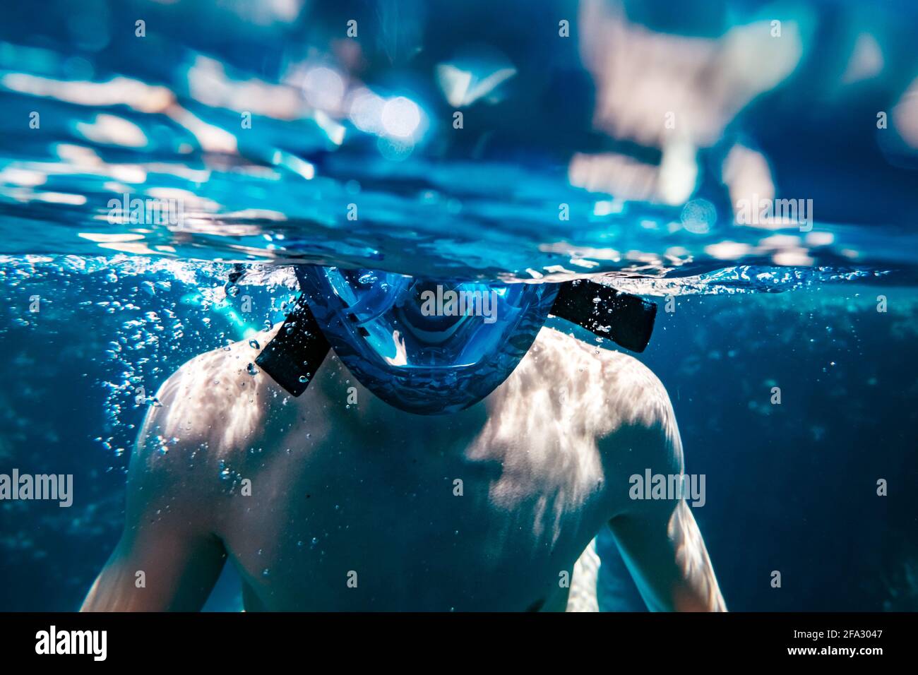 Man in snorkeling mask underwater swimming Stock Photo