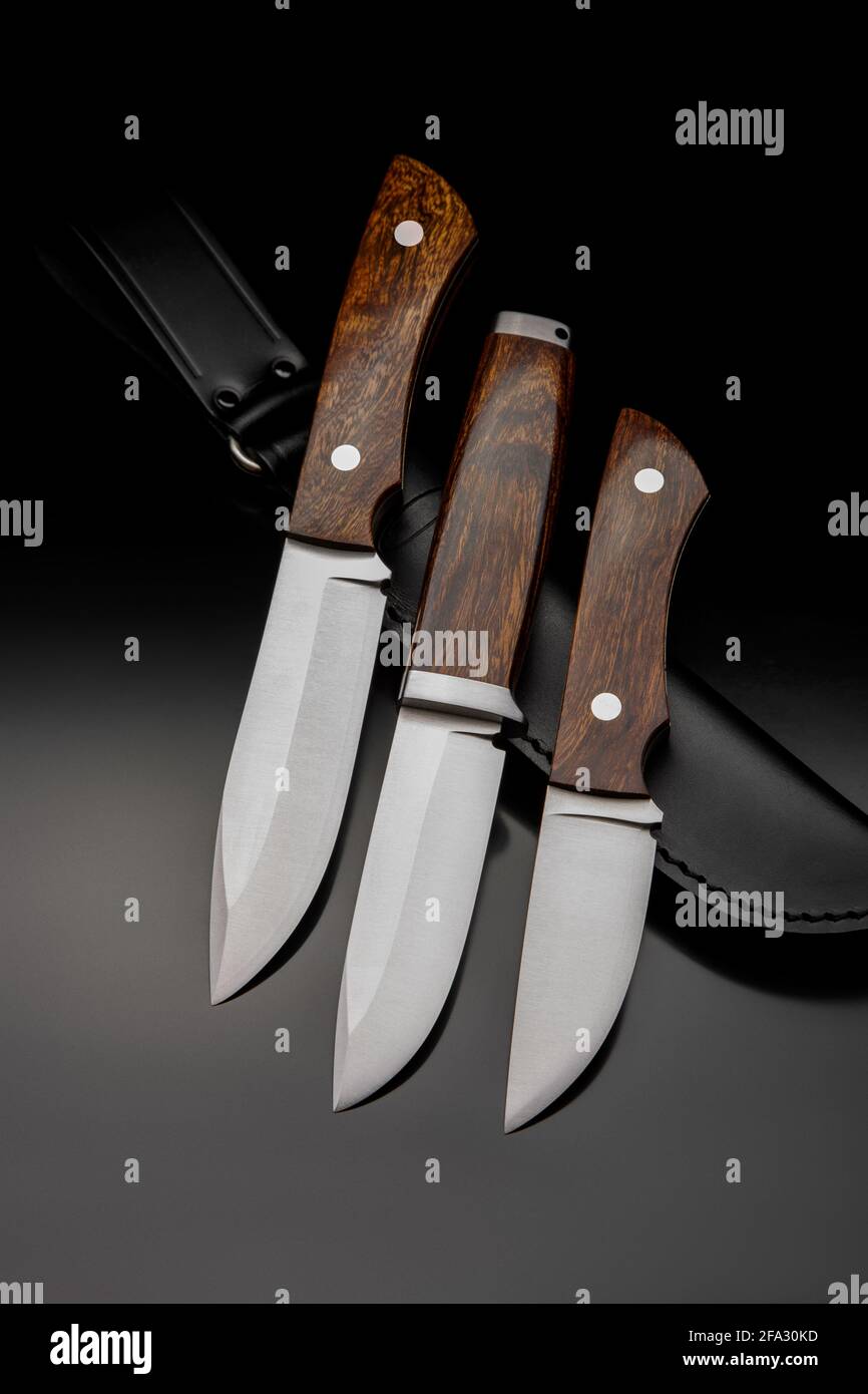 Classic hunting knives with wooden handles. Hunting edged weapons on a