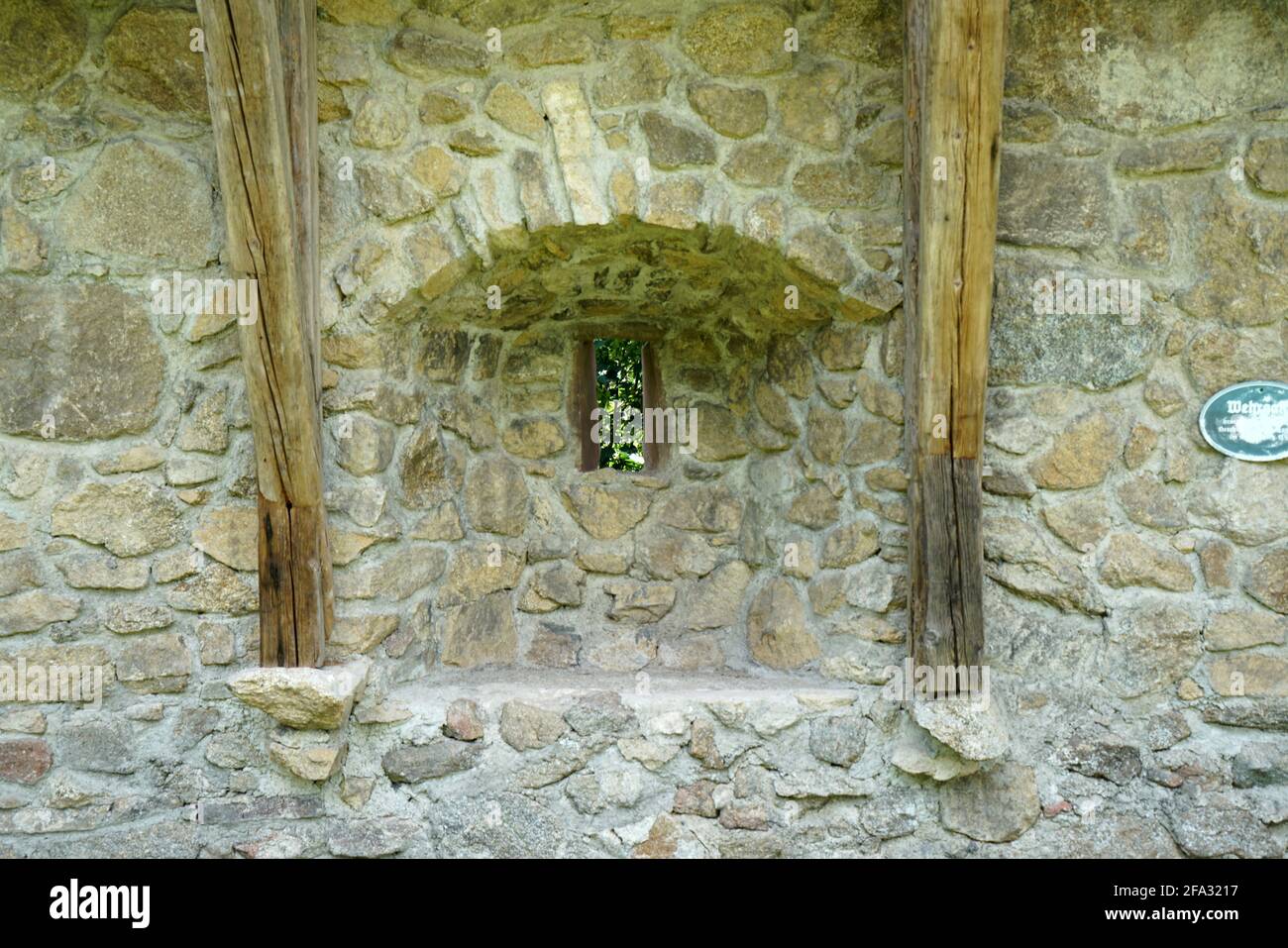 Small window with a roof on a stone wall building Stock Photo - Alamy