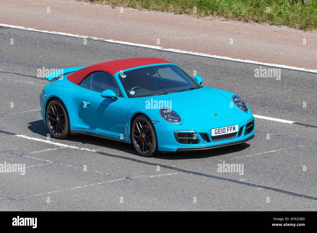 2018 blue red Porsche 911 Carrera 4 Gts; moving vehicles, cars, vehicle driving on UK roads, motors, motoring on the M6 English motorway road network Stock Photo