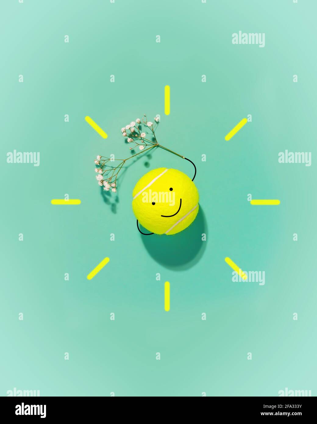Spring sport composition with large tennis ball in the form of a smiley face and flower on blue background. The concept of good mood and well-being fr Stock Photo