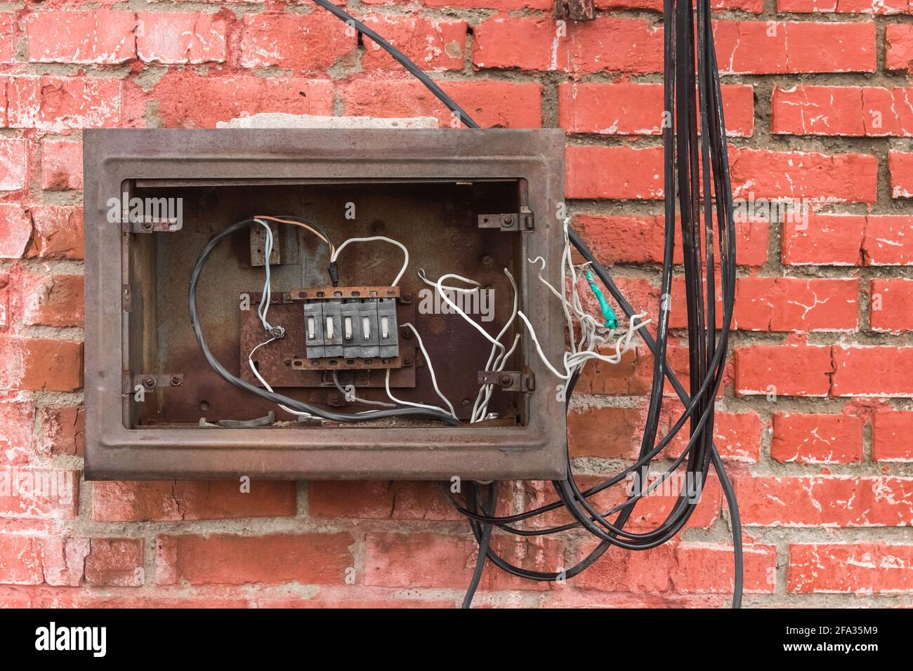Niche of an old broken electrical panel on the background of an old red  brick wall texture Stock Photo - Alamy