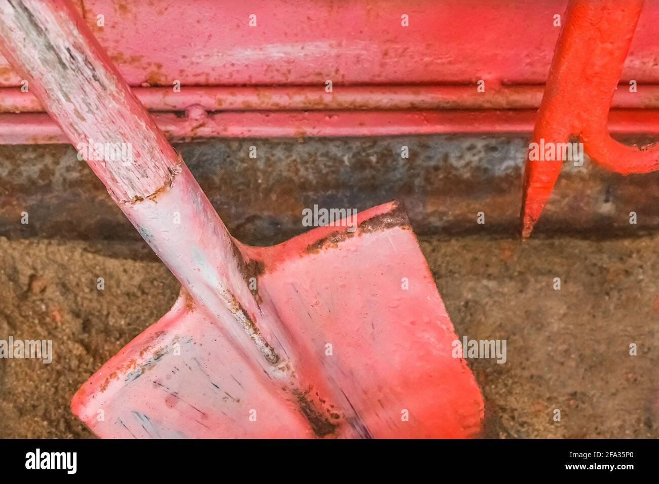 Old fire red box with a shovel and hook and tools to help during a dangerous situation. Stock Photo