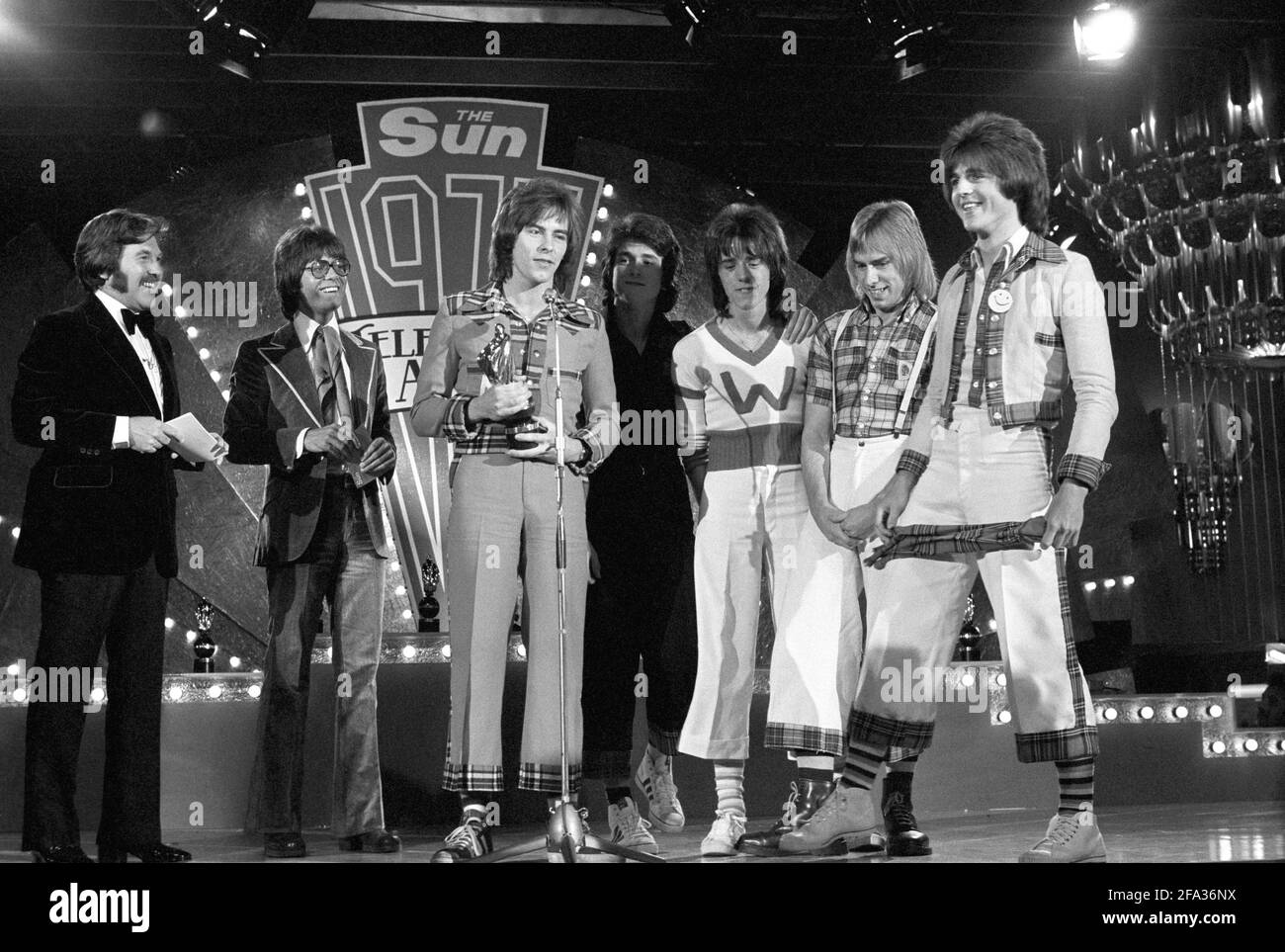 File photo dated 14/06/75 of The Bay City Rollers with the award for the Top Pop Act presented to them by pop star Cliff Richard, second left, at the 1975 Sun Television Awards ceremony at the London Hilton Hotel. Bay City Rollers singer Les McKeown has died at the age of 65. Issue date: Thursday April 22, 2021. Stock Photo