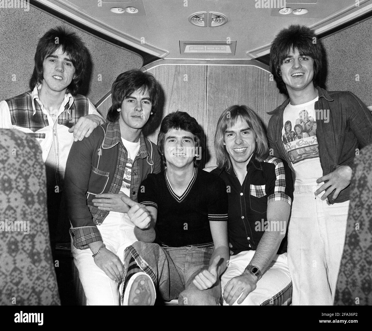 File photo dated 26/11/75 of The Bay City Rollers (left to right) Stuart Wood, Alan Longmuir, Leslie Mckeown, Derek Longmuir, and Eric Faulkner on board a jumbo jet at London's Heathrow Airport before leaving for Perth and a tour of Australia. Bay City Rollers singer Les McKeown has died at the age of 65. Issue date: Thursday April 22, 2021. Stock Photo