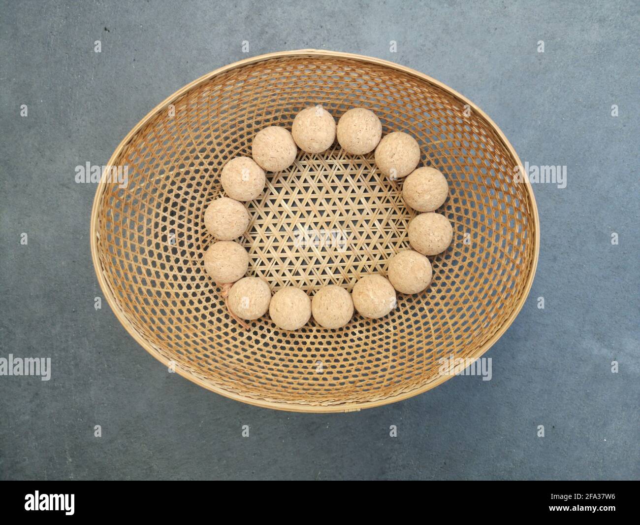 Top view of a thatch basket with small balls in it Stock Photo