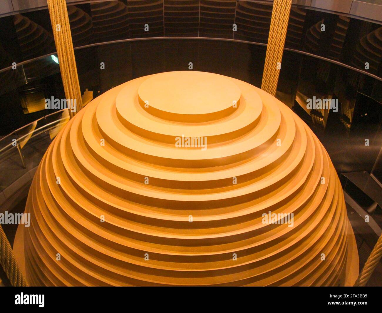 Looking down at the big gold painted steel plate sway damper. In Taipei, Taiwan. Stock Photo