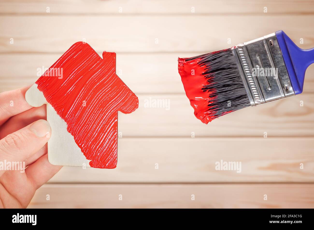 Symbol house painting brush in red colour. New home remodeling renovation paint facade. Painting work house icon renovation home construction model Stock Photo