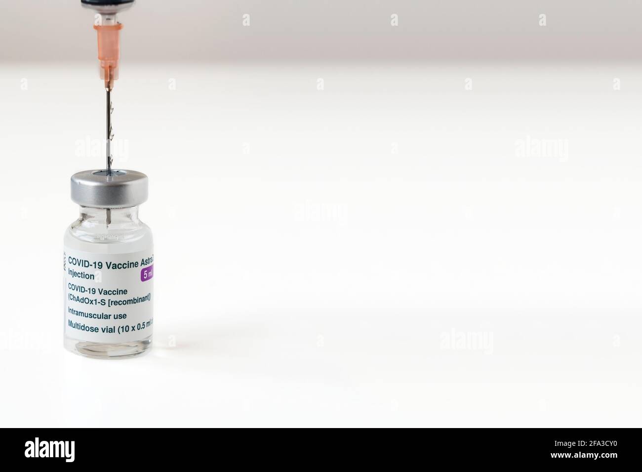 London, UK - 08 Mar 2021: Close-up of Astra Zeneca Pharmaceuticals' coronavirus vaccine next to a syringe. Copy space Stock Photo