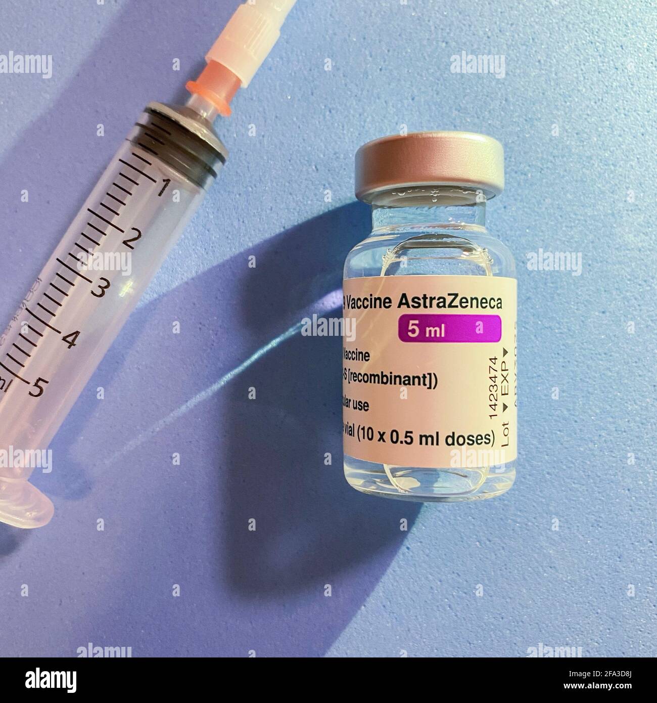 London, UK - 08 Mar 2021: Close-up of Astra Zeneca Pharmaceuticals' coronavirus vaccine next to a syringe Stock Photo