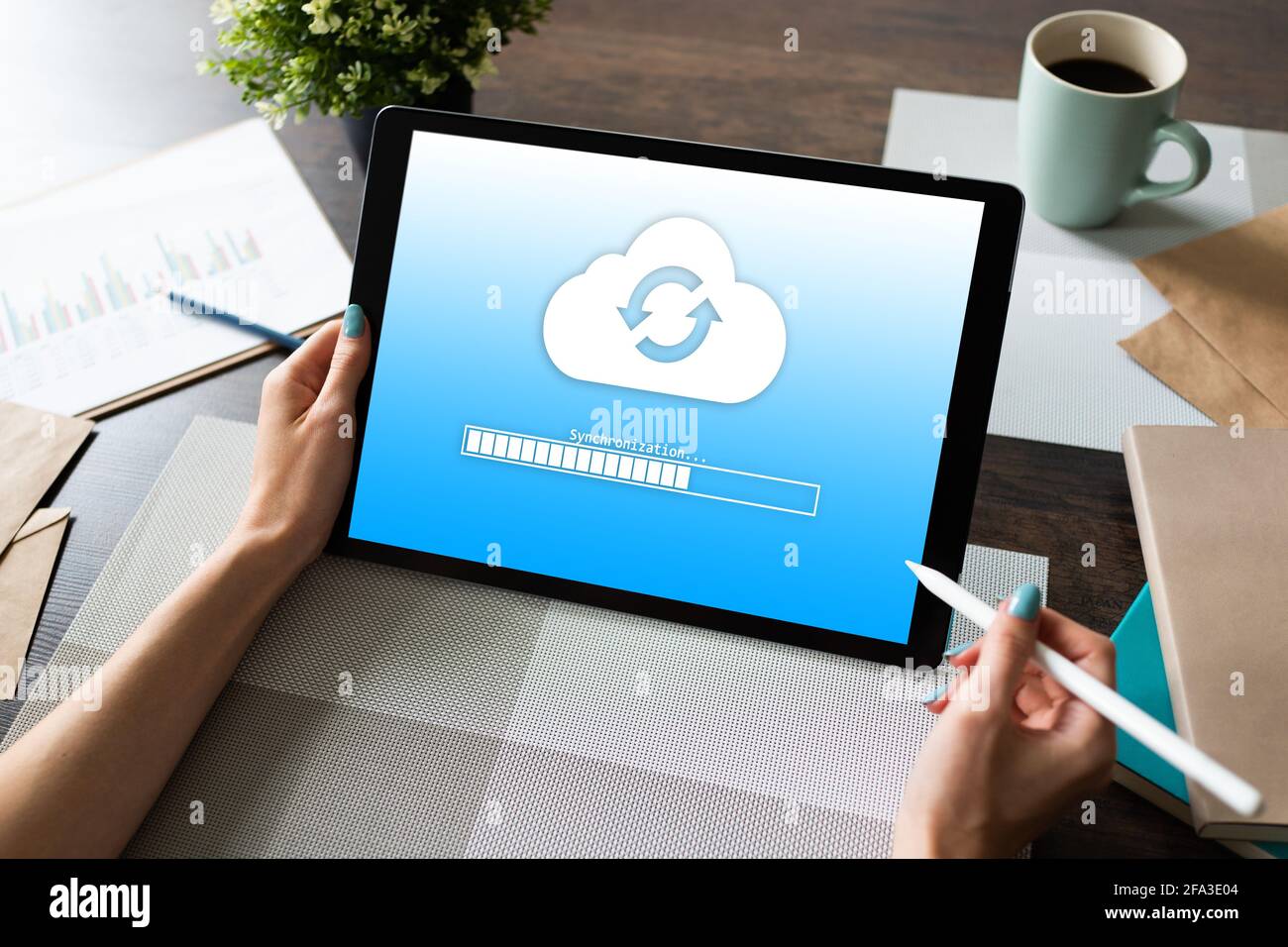 Cloud synchronization progress bar on tablet screen. Data storage and protection. Technology and internet concept Stock Photo
