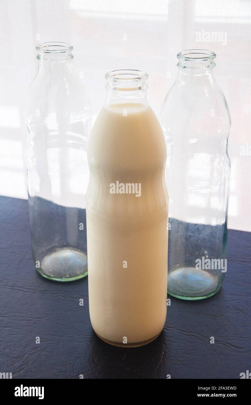 Glass bottles with milk, full and empty Stock Photo Alamy
