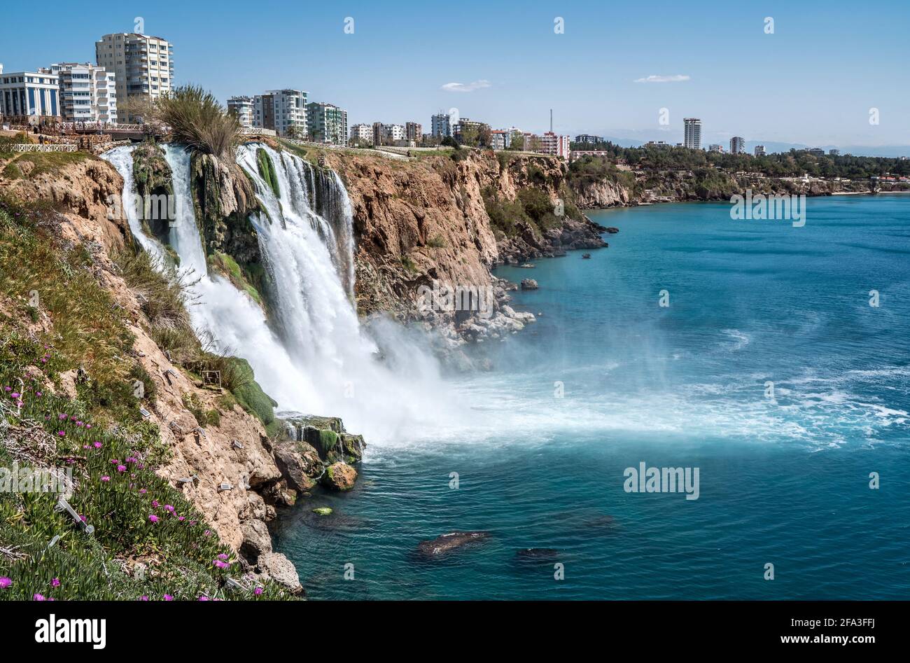 Lower Düden Falls drop off a rocky cliff falling from about 40 m into the Mediterranean Sea in amazing water clouds. Tourism and travel destination ph Stock Photo