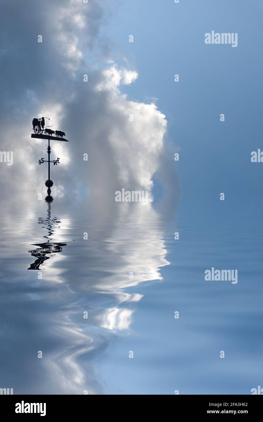 Weather vane reflected in sea Stock Photo