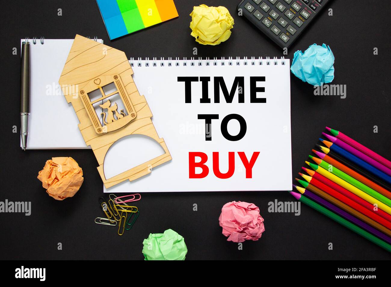 Time to buy real estate symbol. White note with words 'time to buy' on  beautiful black background, metalic pen, calculator, colored pencils,  miniature Stock Photo - Alamy