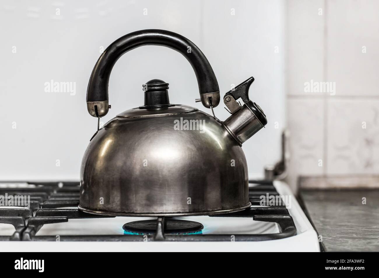 https://c8.alamy.com/comp/2FA3WF2/a-metal-dark-kettle-with-a-whistle-heats-the-water-to-a-boil-on-a-gas-stove-in-the-kitchen-2FA3WF2.jpg