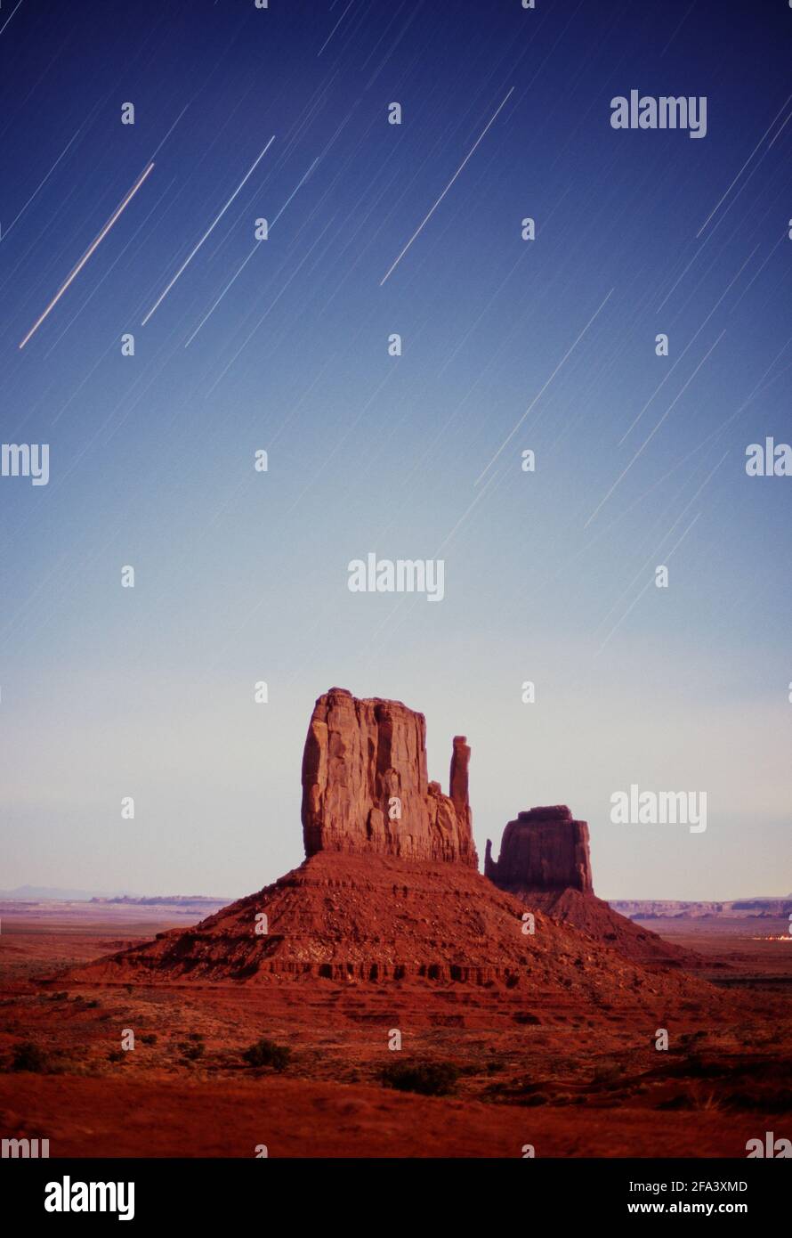 USA, Arizona, Monument Valley, star trails over the Left and Right Mittens Stock Photo