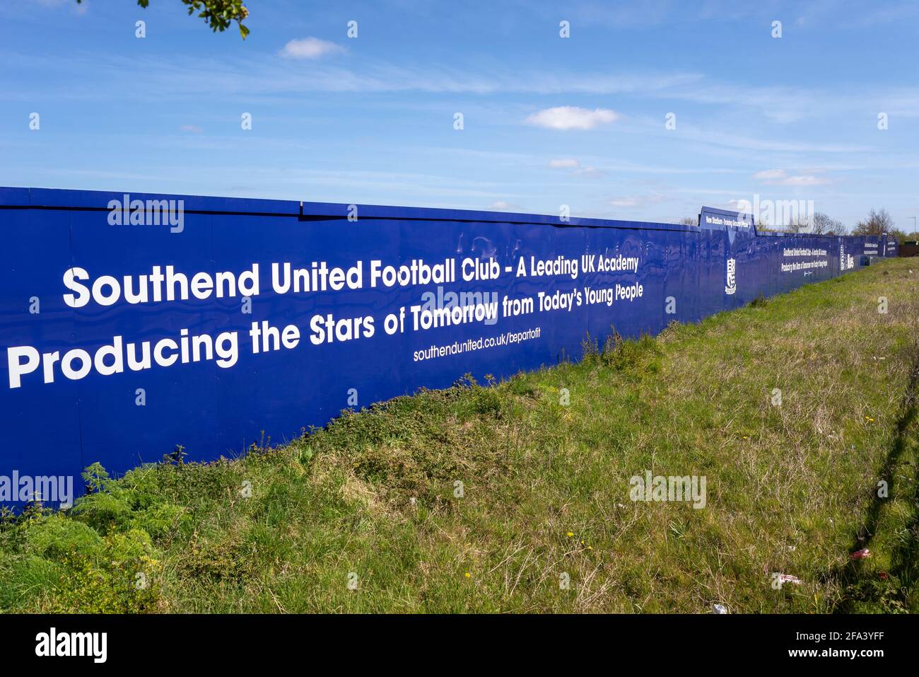 Building site hoarding around proposed Southend Utd football club new stadium training ground in Fossetts Way, Fossetts Farm Stock Photo