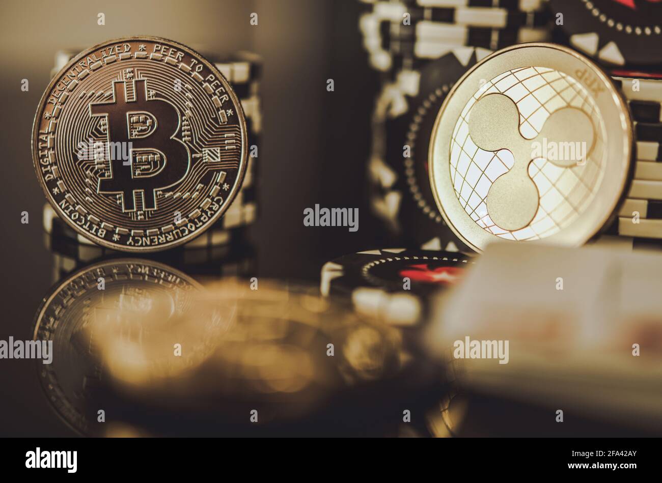 BTC Bitcoin and XRP Ripple Coins Between Casino Chips. Entertainment and Modern Blockchain Payments Concept. Stock Photo