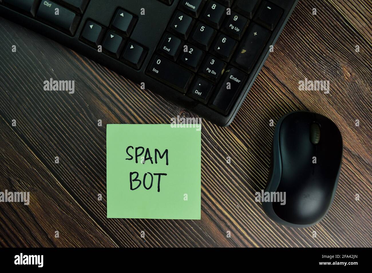Spam Bot write on sticky notes isolated on Wooden Table. Stock Photo