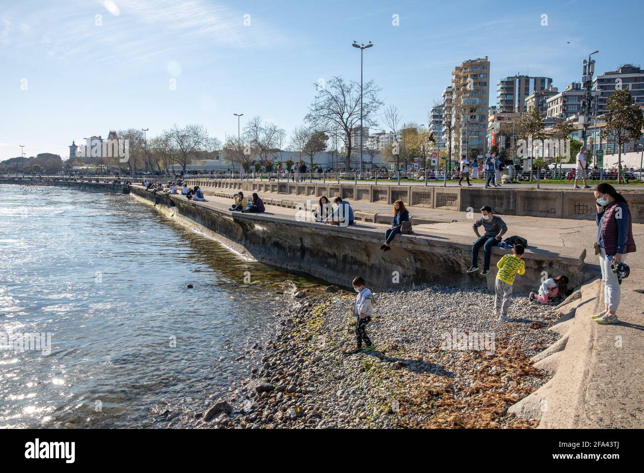 People enjoying beautiful day and sun on Bostanci coasts during pandemic outbreak days before curfew in Kadikoy, Istanbul, Turkey on April 22, 2021. Stock Photo