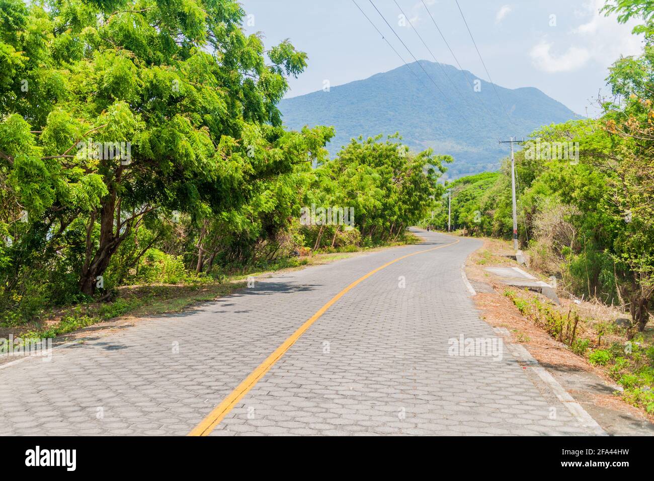 Road and Maderas volcano on Ometepe island, Nicaragua Stock Photo