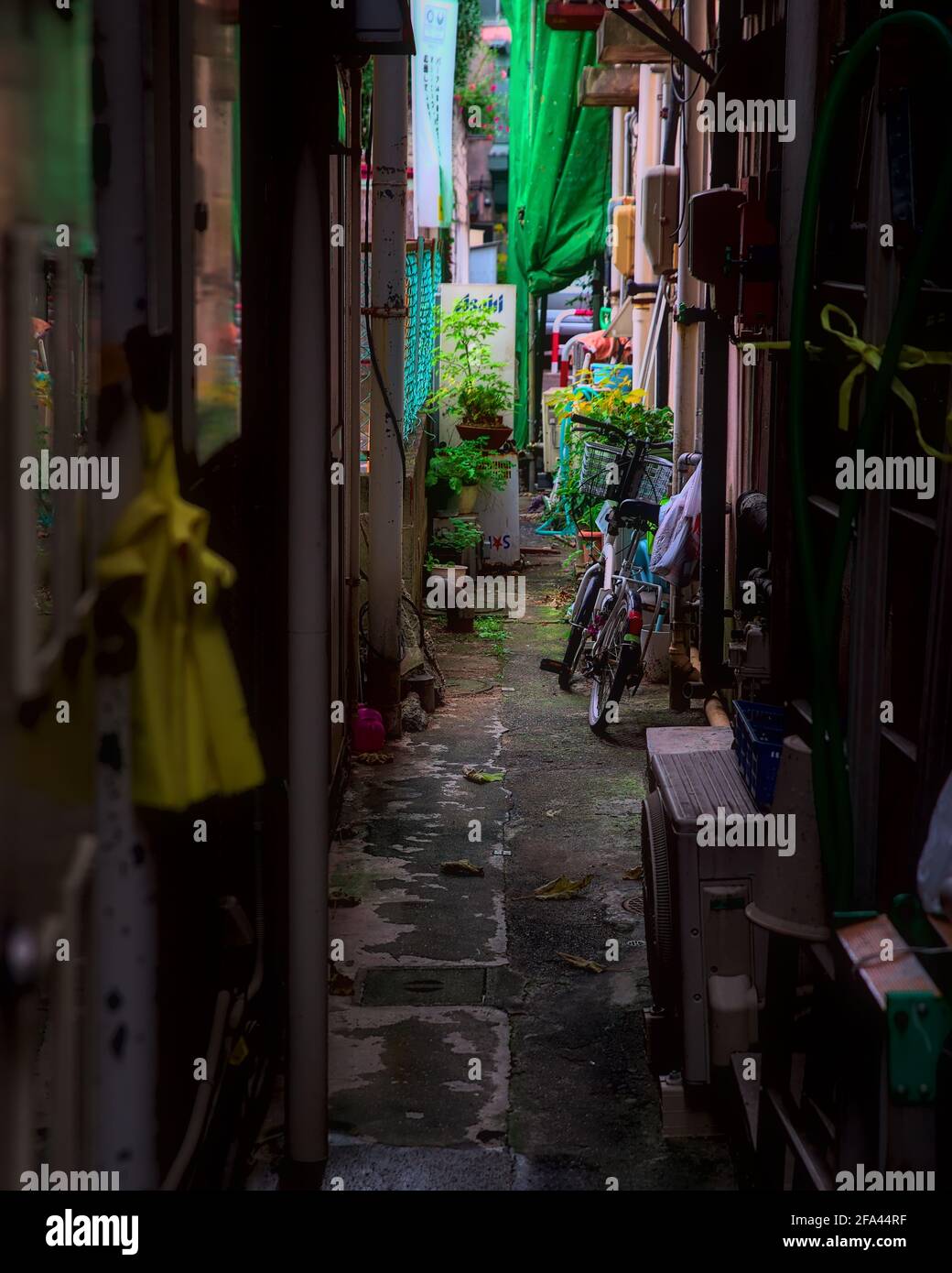 Daytime View Of A Bicycle In A Cluttered Alleyway Between Apartment Buildings In Fukushima City Japan Stock Photo Alamy
