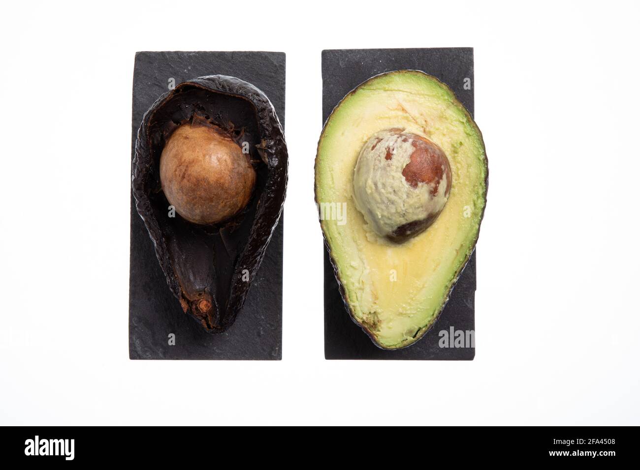 Fresh and ripe avocado next to rotting avocado cut in half with seed ...