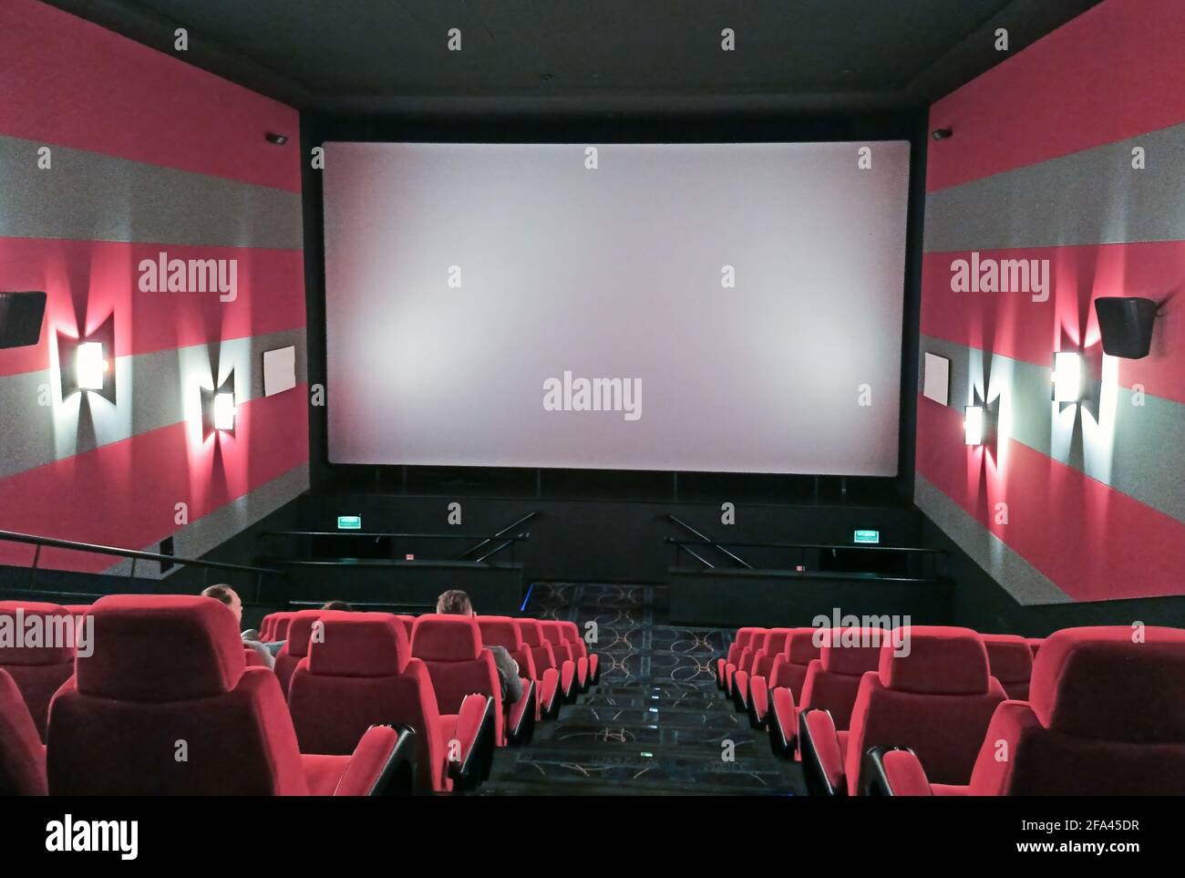 Interior of a modern empty red cinema hall in theater with armchairs and  lights Stock Photo - Alamy