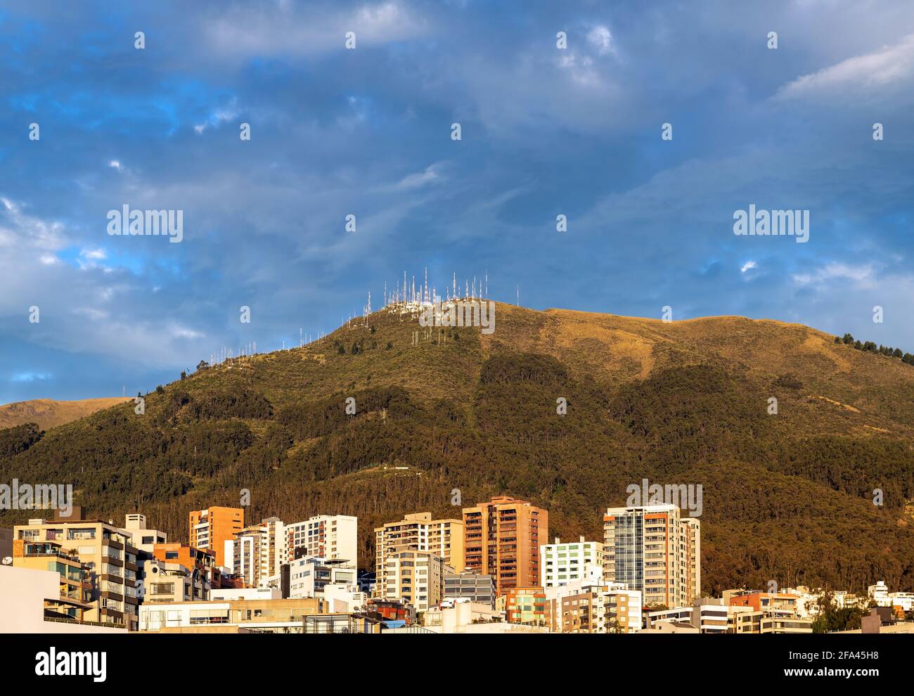 Modern apartment buildings by Pichincha volcano at sunrise, Quito, Pichincha province, Ecuador. Stock Photo