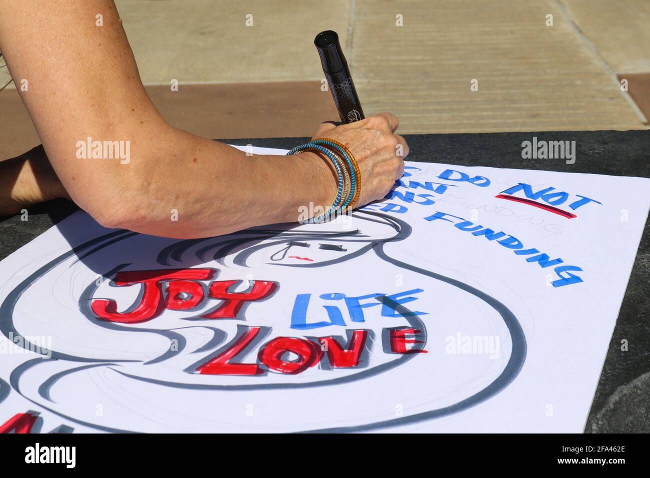 Tulsa Oklahoma USA 3 24 2018   Woman working on sign with marker for March for Life protest Stock Photo