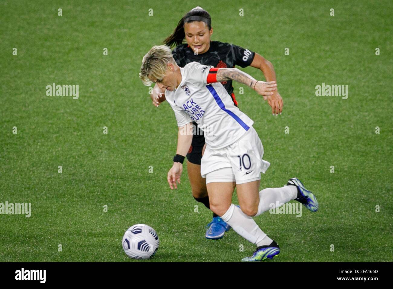 Portland, USA. 21st Apr, 2021. The Reign's Jessica Fishlock (10) steals the ball. The Portland Thorns FC beat Tacoma's OL Reign 2-0 at Providence Park in Portland, Oregon on April 21, 2021, which sends the Thorns to the Challenge Cup finals at home on May 8. (Photo by John Rudoff/Sipa USA) Credit: Sipa USA/Alamy Live News Stock Photo